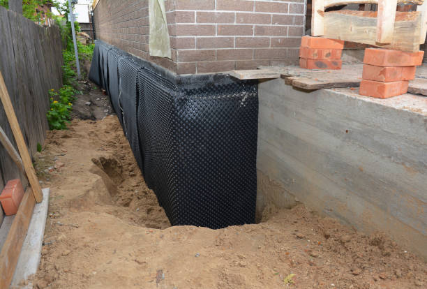 Happy homeowners after waterproofing job in Edon